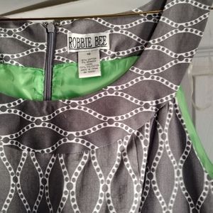 A gray w/ white pattern ( wave, dot). Size 14. The brand Robbie bee.